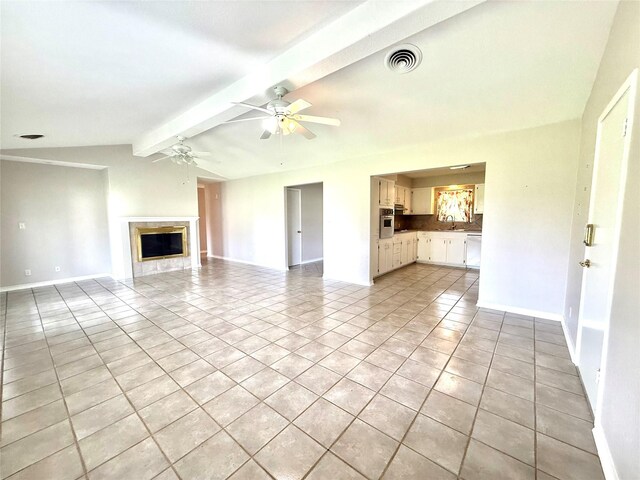 1206 Kent St, Sweeny, TX 77480 - unfurnished living room with visible vents, vaulted ceiling with beams, light tile patterned floors, a sink, and ceiling fan