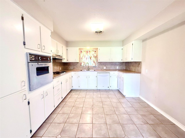 1206 Kent St, Sweeny, TX 77480 - kitchen with dishwasher, under cabinet range hood, backsplash, and oven