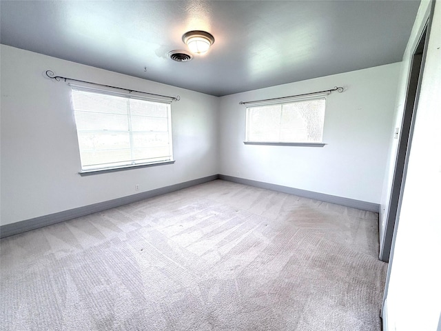 1206 Kent St, Sweeny, TX 77480 - spare room featuring baseboards, visible vents, and light colored carpet