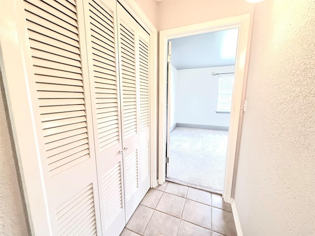 1206 Kent St, Sweeny, TX 77480 - hall with a textured wall, baseboards, light carpet, and light tile patterned floors
