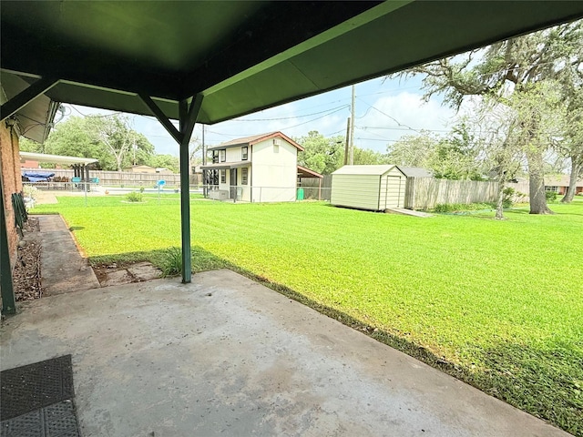 1206 Kent St, Sweeny, TX 77480 - exterior space featuring a fenced backyard, an outdoor structure, a patio, and a storage unit