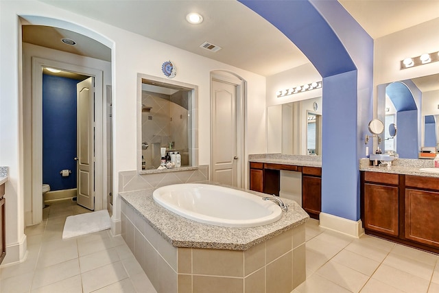 full bath with a shower stall, tile patterned floors, visible vents, vanity, and a garden tub
