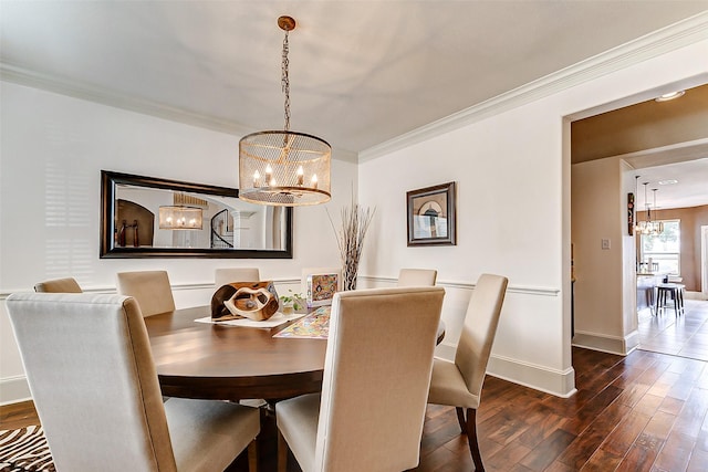 dining space with a chandelier, dark wood finished floors, baseboards, and ornamental molding