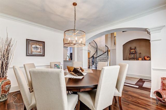 dining space with stairway, a notable chandelier, wood finished floors, arched walkways, and ornamental molding