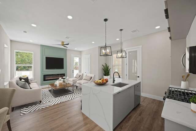 kitchen with open floor plan, a sink, stainless steel appliances, and a healthy amount of sunlight
