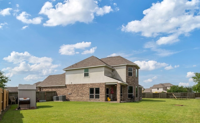 3203 Jeanette Cir, Mont Belvieu, TX 77523 - rear view of house with brick siding and central air condition unit