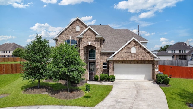 3203 Jeanette Cir, Mont Belvieu, TX 77523 - view of front facade with brick siding, concrete driveway, a shingled roof, and a garage