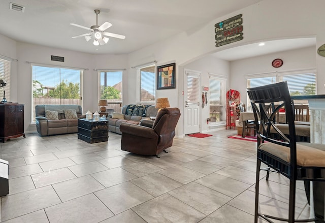 3203 Jeanette Cir, Mont Belvieu, TX 77523 - living room featuring a ceiling fan, light tile patterned flooring, and arched walkways