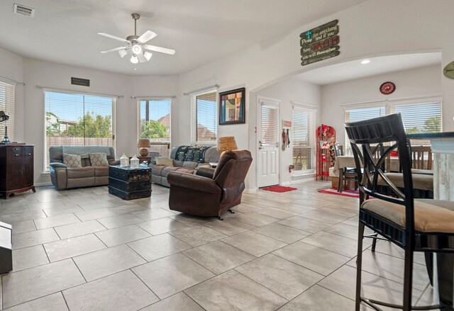 3203 Jeanette Cir, Mont Belvieu, TX 77523 - living room with ceiling fan, light tile patterned flooring, and arched walkways