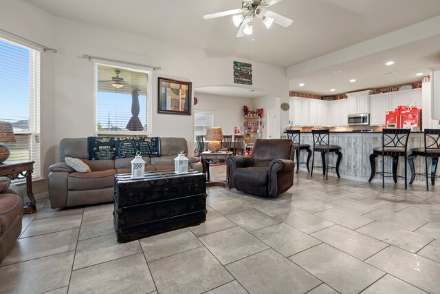 3203 Jeanette Cir, Mont Belvieu, TX 77523 - living room with a ceiling fan, healthy amount of natural light, light tile patterned flooring, arched walkways, and recessed lighting