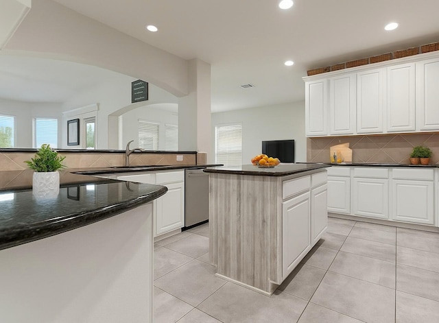 3203 Jeanette Cir, Mont Belvieu, TX 77523 - kitchen with stainless steel dishwasher, plenty of natural light, a sink, tasteful backsplash, and recessed lighting