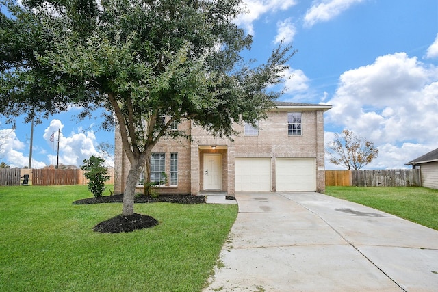 traditional-style home with brick siding, an attached garage, a front yard, and driveway