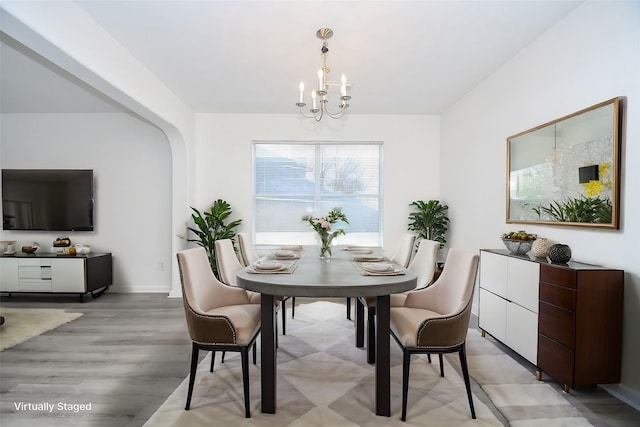 dining area with a notable chandelier and light wood-style floors
