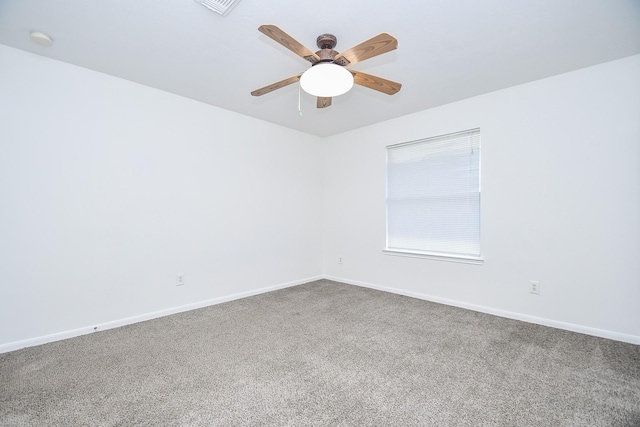 carpeted empty room featuring baseboards and ceiling fan