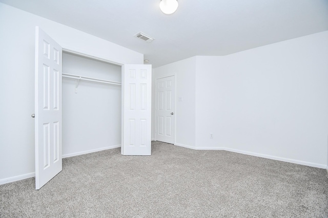unfurnished bedroom with baseboards, a closet, visible vents, and carpet