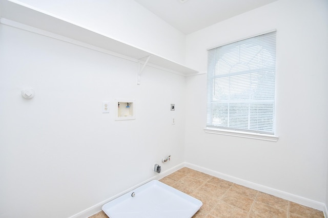 washroom with hookup for an electric dryer, baseboards, washer hookup, hookup for a gas dryer, and laundry area