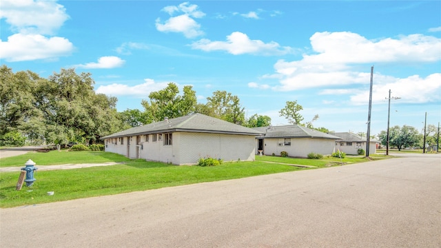 view of property exterior with a lawn