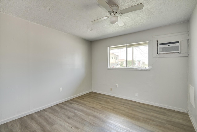 5409 Suez St Unit 4, Houston, TX 77020 - unfurnished room featuring wood finished floors, an AC wall unit, a textured ceiling, and a ceiling fan