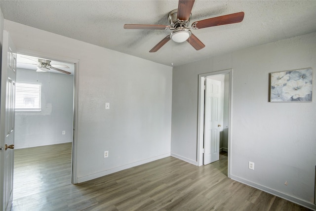 5409 Suez St Unit 4, Houston, TX 77020 - unfurnished room with wood finished floors, a textured ceiling, a ceiling fan, and baseboards