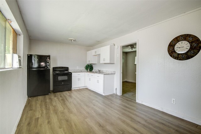 5409 Suez St Unit 4, Houston, TX 77020 - kitchen with white cabinets, light wood finished floors, a ceiling fan, baseboards, and black appliances