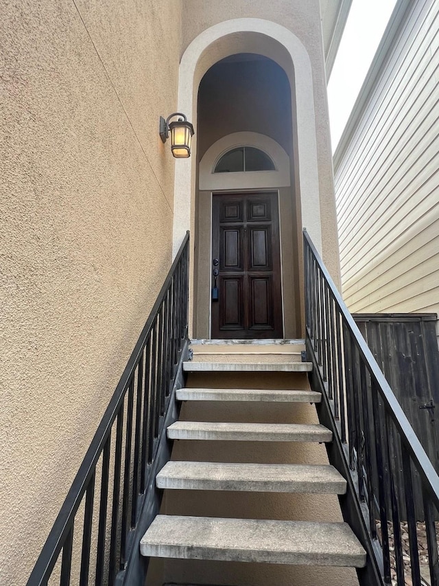 doorway to property with stucco siding