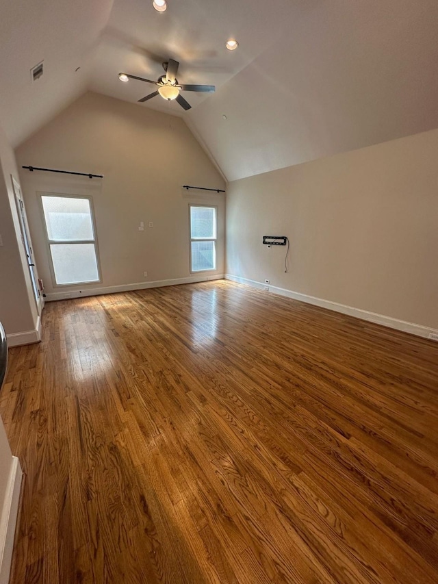 interior space featuring lofted ceiling, visible vents, a ceiling fan, and wood finished floors