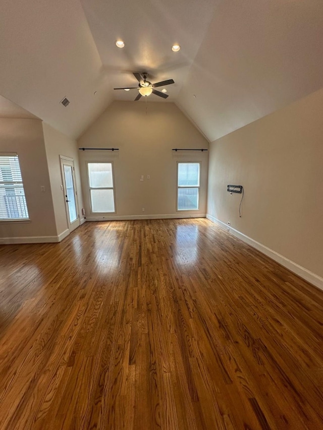 unfurnished living room with lofted ceiling, a ceiling fan, baseboards, and wood finished floors