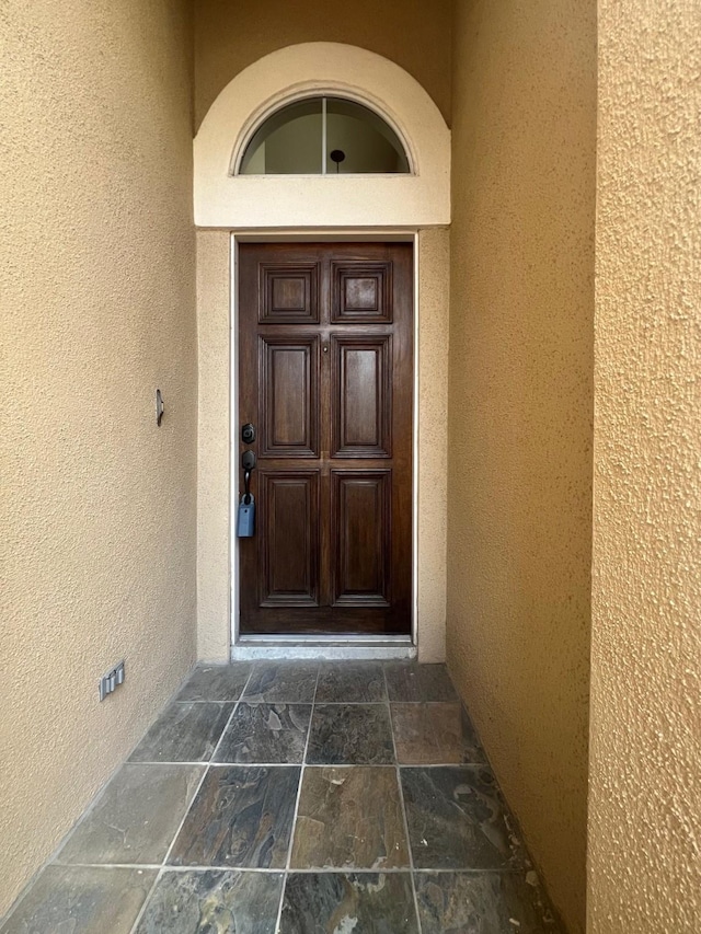 doorway to property with stucco siding