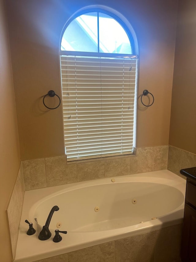 bathroom featuring vanity and a whirlpool tub
