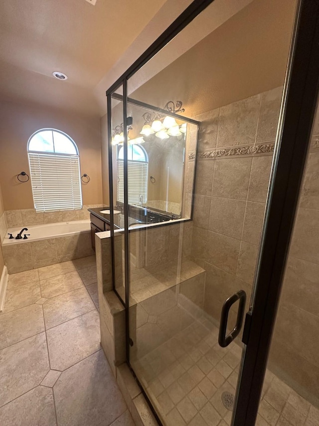 full bathroom with a garden tub, tile patterned flooring, and a stall shower