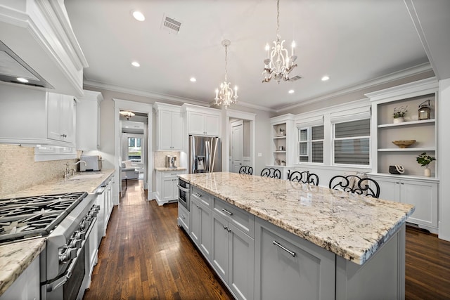 kitchen featuring visible vents, an inviting chandelier, appliances with stainless steel finishes, and crown molding