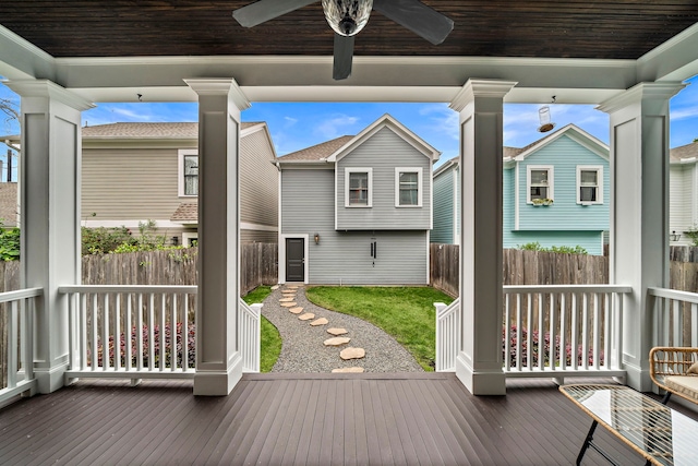 deck featuring a yard, fence, and a ceiling fan