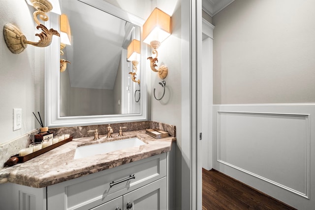 bathroom featuring wood finished floors, vanity, and ornamental molding