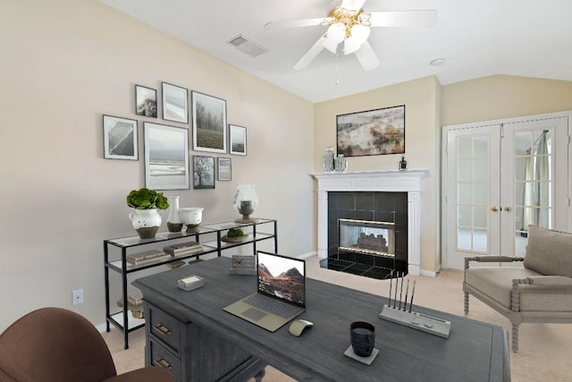 2538 Silent Shore Ct, Richmond, TX 77406 - office featuring light carpet, ceiling fan, french doors, vaulted ceiling, and a tiled fireplace