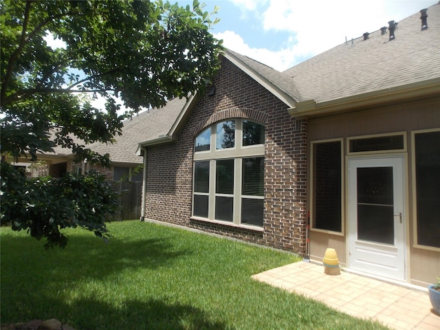 23423 Tavola Rosa Dr, New Caney, TX 77357 - rear view of property with brick siding, roof with shingles, and a yard