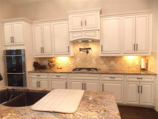 23423 Tavola Rosa Dr, New Caney, TX 77357 - kitchen with stainless steel appliances, white cabinets, and backsplash