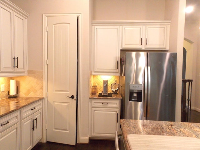 23423 Tavola Rosa Dr, New Caney, TX 77357 - kitchen featuring stainless steel fridge with ice dispenser, white cabinets, backsplash, and light stone countertops