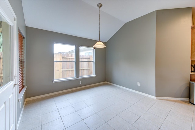 unfurnished dining area featuring vaulted ceiling, baseboards, and light tile patterned floors