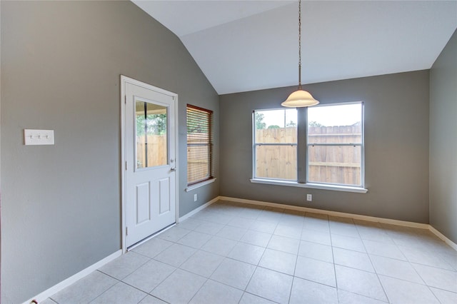 unfurnished dining area featuring light tile patterned floors, lofted ceiling, and baseboards