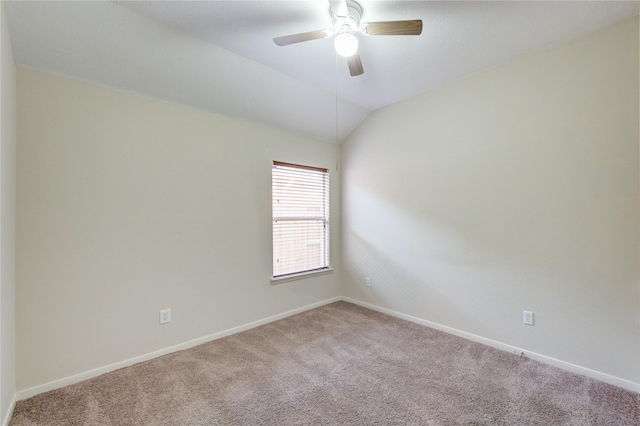 empty room with ceiling fan, baseboards, lofted ceiling, and carpet flooring