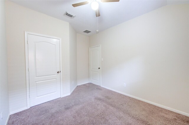 unfurnished bedroom with baseboards, visible vents, and carpet