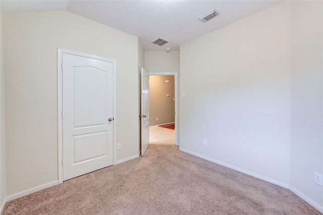 unfurnished bedroom with baseboards, visible vents, and carpet