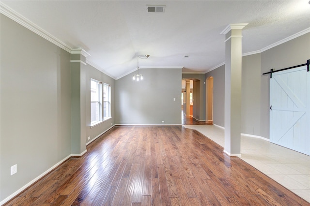 unfurnished living room with wood finished floors, visible vents, arched walkways, and ornamental molding