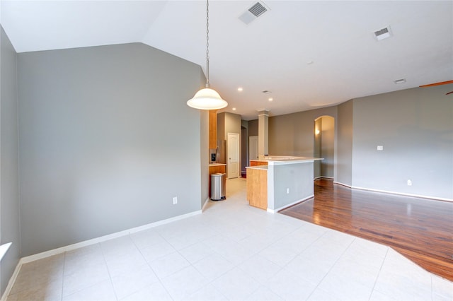 empty room featuring recessed lighting, arched walkways, visible vents, and baseboards