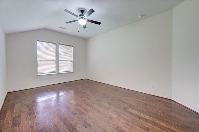 unfurnished room featuring vaulted ceiling, baseboards, dark wood-type flooring, and a ceiling fan