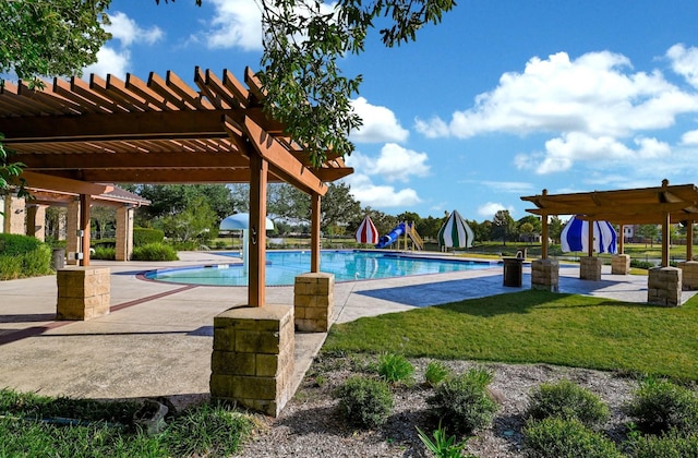 pool with a lawn, a patio area, and a pergola