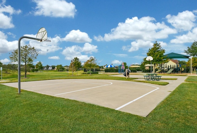 view of sport court featuring a lawn, community basketball court, and playground community
