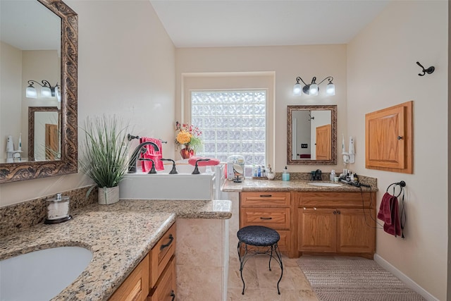bathroom featuring two vanities and a sink