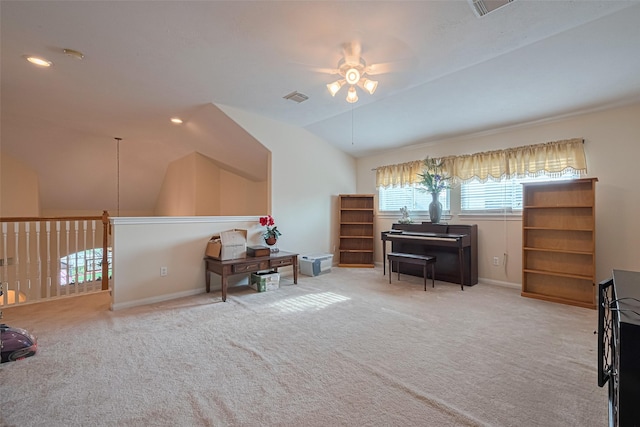 sitting room with visible vents, carpet floors, lofted ceiling, baseboards, and a ceiling fan