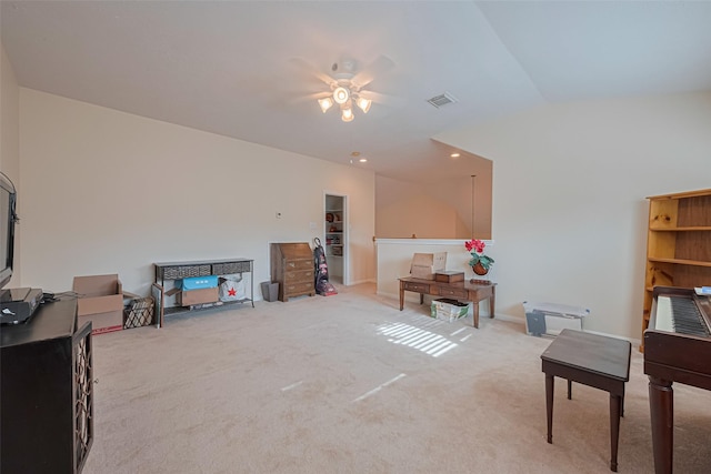 carpeted office space featuring baseboards, a ceiling fan, and visible vents